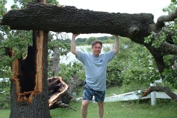 Photo of Robert Brandon K5PI and broken Live Oak 
          tree, June, 2003